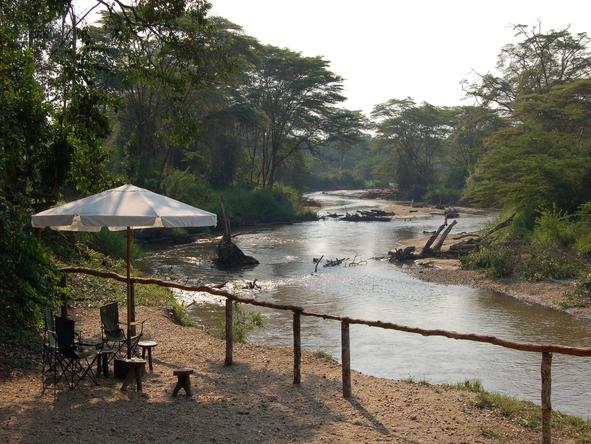 Ishasha Wilderness Camp - umbrella on river bank