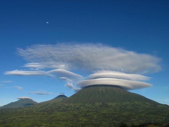 Circular clouds move in incredible formations over the Volcanoes mountain range.