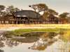 Onguma Tree-Top Camp - lodge exterior + waterhole