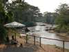 Ishasha Wilderness Camp - umbrella on river bank