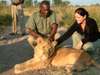 Sharlene Swart - petting a young lion at Victoria Falls