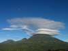 Circular clouds move in incredible formations over the Volcanoes mountain range.